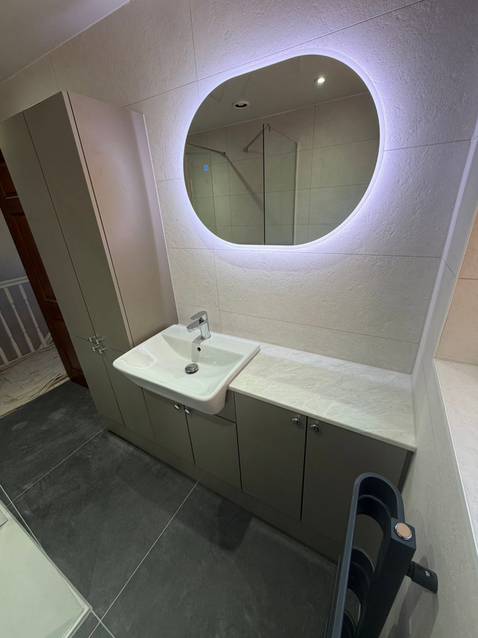 Fitted bathroom vanity unit with backlit mirror