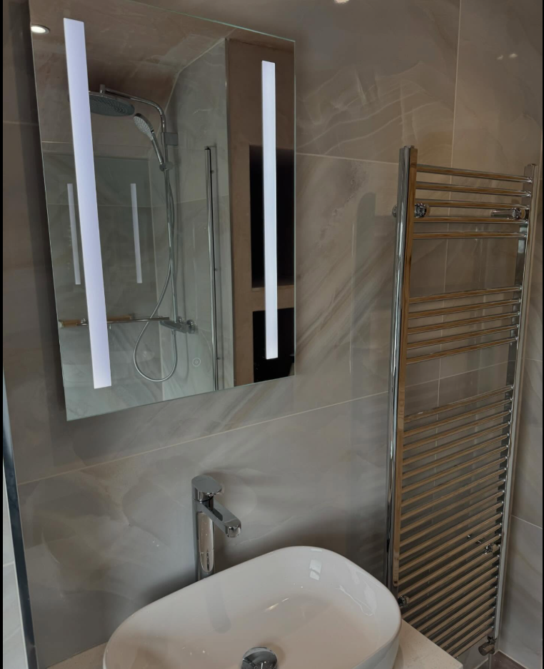 Countertop basin, chrome tall mixer and heated towel rail installation