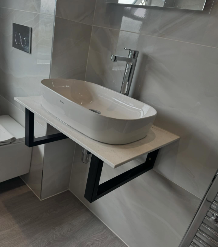 Wall-hung countertop basin on a stone shelf with concealed cistern plumbing