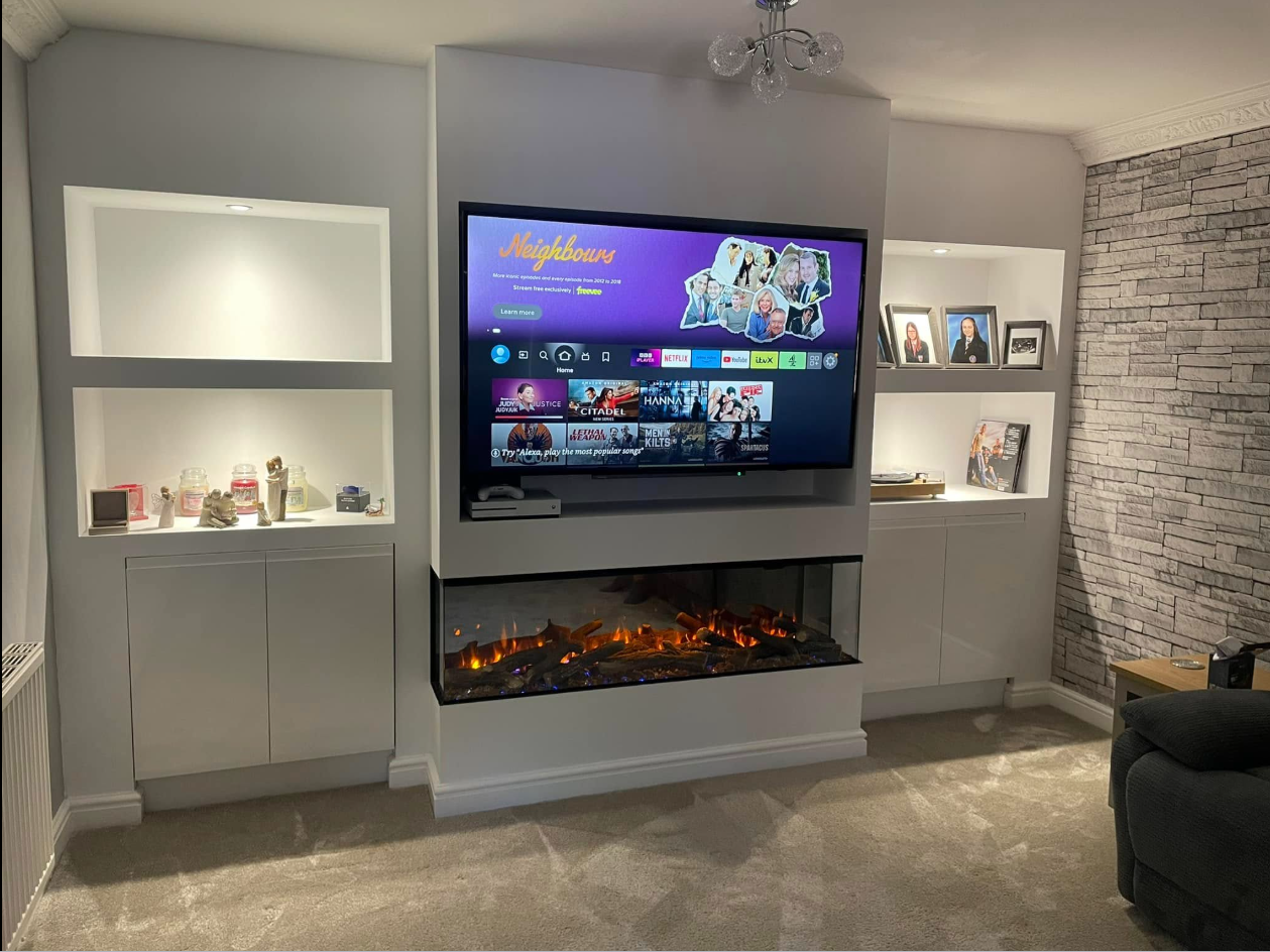 Finished media wall with inset electric fire, TV recess and fitted cabinetry